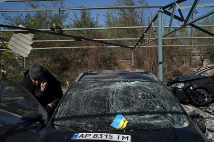 Dmytro Pocishchuk checks his car, which was damaged after a Russian attack in Zaporizhzhia, Ukraine, Saturday, Oct. 15, 2022. AP/RSS Photo