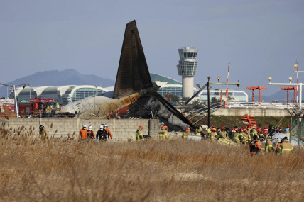 Firefighters and rescue team members work at Muan International Airport in Muan, South Korea, Sunday, Dec. 29, 2024. (AP)