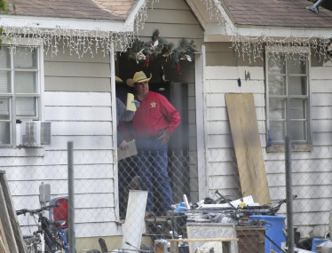 San Jacinto County Sheriff Greg Capers talks to investigators at the scene where five people were shot and killed the night before, Saturday, April 29, 2023, in unincorporated San Jacinto County, Texas.  AP/RSS Photo