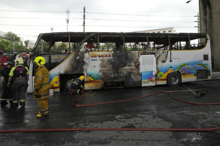 Rescuers work at the site of a bus that caught fire, carrying young students with their teachers, in suburban Bangkok, Tuesday, Oct. 1, 2024. (AP Photo)