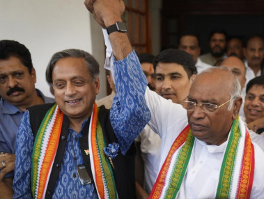 Congress party leader Shashi Taroor, and contender for the party president position, left, raises hands with newly elected president Mallikarjun Kharge in New Delhi, India, Wednesday, Oct 19, 2022. (AP/RSS Photo)
