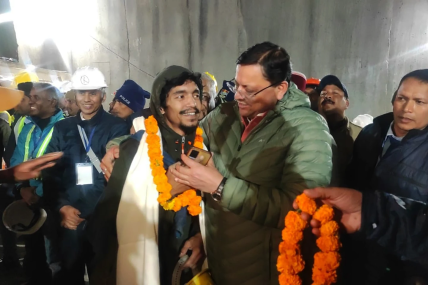 This handout photo provided by the Uttarakhand State Department of Information and Public Relations shows Pushkar Singh Dhami, right, Chief Minister of the state of Uttarakhand, greeting a worker rescued from the site of an under-construction road tunnel that collapsed in Silkyara in the northern Indian state of Uttarakhand, India, Tuesday, Nov. 28, 2023. AP/RSS Photo