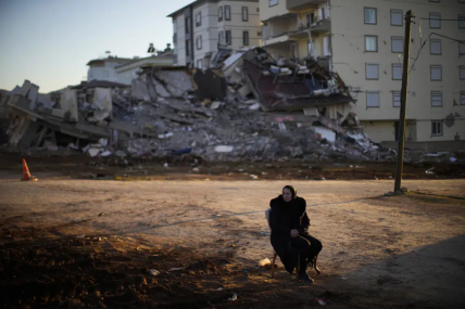 Fatos Baruc, who lives in Germany and whose mother-in-law survived the earthquake, sits on a chair as she waits for her belongings to take away from a damaged building in Pazarcik, Turkey, Monday, Feb. 13, 2023. AP/RSS Photo
