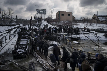 FILE - Ukrainians cross an improvised path under a destroyed bridge while fleeing Irpin, in the outskirts of Kyiv, Ukraine, Tuesday, March 8, 2022. AP/RSS Photo