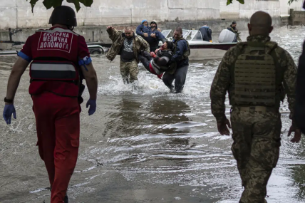 Emergency teams help rush to safety injured civilian evacuees who had came under fire from Russian forces while trying to flee by boat from the Russian-occupied east bank of a flooded Dnieper River to Ukrainian-held Kherson, on the western bank in Kherson, Ukraine on Sunday, June 11, 2023. AP/RSS Photo