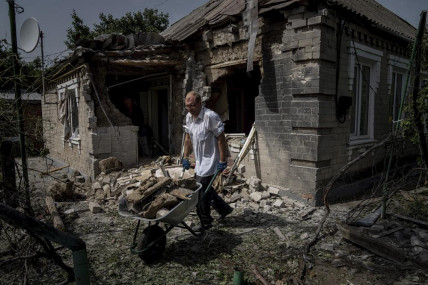 Dmyto Shengur cleans rubble in front of the house which was damaged after Russian bombardment of residential area in Nikopol, Ukraine, on Monday, Aug, 22, 2022.  AP/RSS Photo