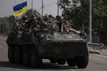 FILE - Ukrainian servicemen ride atop of an armored vehicle on a road in Donetsk region, eastern Ukraine, Sunday, Aug. 28, 2022.  AP/RSS Photo