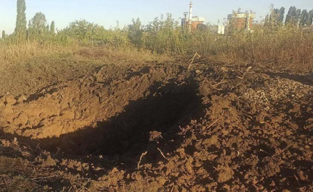 In this photo provided by the South Ukraine nuclear power plant, a crater left by a Russian rocket is seen 300 meter from the South Ukraine nuclear power plant, in the background, close to Yuzhnoukrainsk, Mykolayiv region, Ukraine, Monday, Sept. 19, 2022. AP/RSS Photo