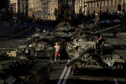 People walk around destroyed Russian military vehicles installed in downtown Kyiv, Ukraine, Wednesday, Aug. 24, 2022. AP/RSS Photo