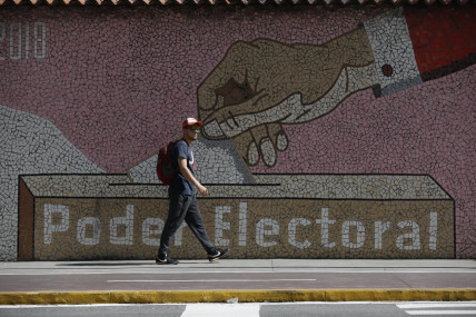 A man walks by a mural depicting a ballot box, outside the headquarters of the National Electoral Council in Caracas, Venezuela, Wednesday, July 31, 2024, three days after the country’s disputed presidential election. AP/RSS Photo