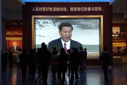 Chinese President Xi Jinping is seen on a big screen below the slogan "The People's desire for the good life, is the goal of our efforts" at the Museum of the Community Party of China in Beijing, Wednesday, Oct 12, 2022. (AP/RSS Photo)