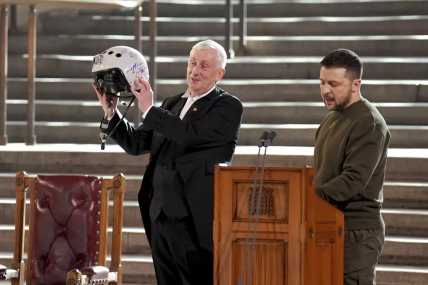 Speaker of the House of Commons, Sir Lindsay Hoyle, left, holds the helmet of one of the most successful Ukrainian pilots, inscribed with the words "We have freedom, give us wings to protect it", which was presented to him by Ukrainian President Volodymyr Zelenskyy as he addressed parliamentarians in Westminster Hall, London, during his first visit to the UK since the Russian invasion of Ukraine, Wednesday Feb. 8, 2023. AP/RSS Photo