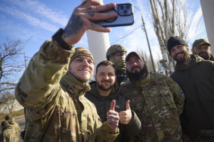 In this photo provided by the Ukrainian Presidential Press Office and posted on Facebook, Ukrainian soldiers take a selfie with President Volodymyr Zelenskyy, centre, during his visit to Kherson, Ukraine, Monday, Nov. 14, 2022. AP/RSS Photo