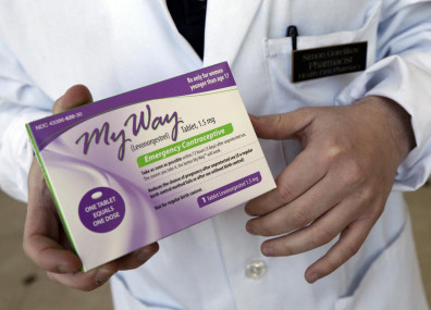FILE - Pharmacist Simon Gorelikov holds a generic emergency contraceptive at the Health First Pharmacy in Boston on May 2, 2013.  AP/RSS Photo