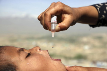 FILE - An Afghan health worker uses an oral polio vaccine on a child as part of a campaign to eliminate polio, on the outskirts of Kabul, Afghanistan, April 18, 2017. AP/RSS Photo