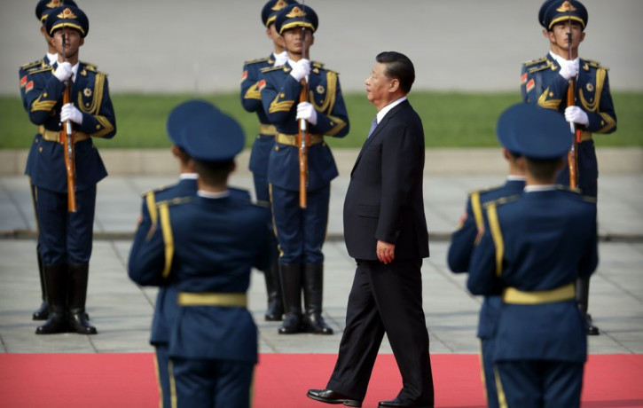 Chinese President Xi Jinping walks past an honor guard as he approaches the Monument to the People's Heroes during a ceremony to mark Martyr's Day at Tiananmen Square in Beijing, Monday, Sept