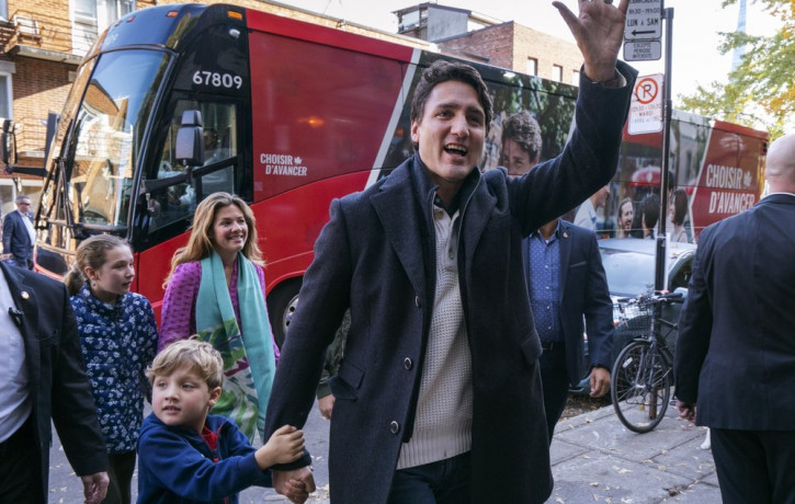 Canadian Prime Minister and Liberal leader Justin Trudeau arrives at the poling station with his son Hadrian, his wife Sophie and daughter Ella-Grace in Montreal, Monday, Oct. 21, 2019.
