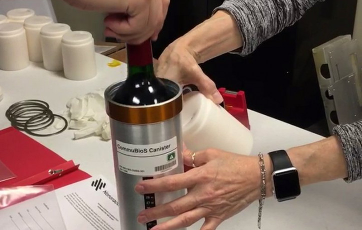 In this Saturday, Nov. 2, 2019 photo provided by Space Cargo Unlimited, researchers with Space Cargo Unlimited prepare bottles of French red wine to be flown aboard a Northrop Grumman capsule
