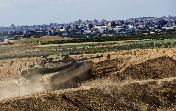 In this Oct. 27, 2018, file photo, Israeli tank takes a position at the Gaza Strip border. The Israeli military on Wednesday said it has carried out a “wide-scale” strike on Iranian targets i