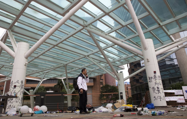 Professor Alex Wai, Vice President of the Polytechnic University, takes in the vandalized campus as he leads a team of school officials and first aid providers.