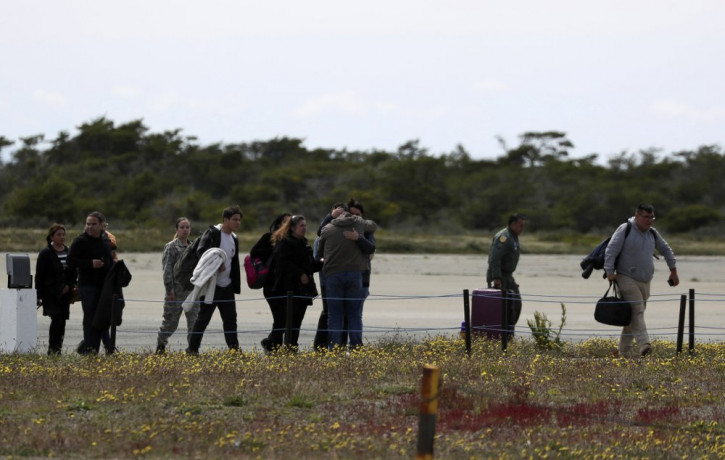 Relatives of passengers of a missing military plane arrive to an airbase in Punta Arenas, Chile, Wednesday, Dec. 11, 2019.