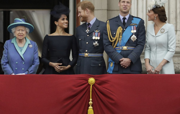 File photo of Britain's Queen Elizabeth II, and from left, Meghan the Duchess of Sussex, Prince Harry, Prince William and Kate the Duchess of Cambridge