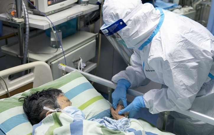 In this Friday, Jan. 24, 2020, photo released by China's Xinhua News Agency, a medical worker attends to a patient in the intensive care unit at Zhongnan Hospital of Wuhan University in Wuhan