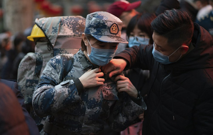 In this photo taken Jan 24, 2020 and released by Xinhua News Agency, a military medic from the Air Force Medical University prepares to leave for Wuhan from Xi'an, capital of northwestern Chi