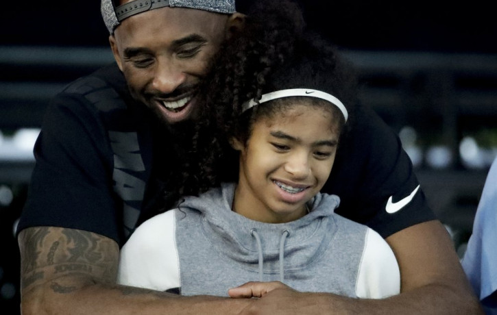 In this July 26, 2018 file photo former Los Angeles Laker Kobe Bryant and his daughter Gianna watch during the U.S. national championships swimming meet in Irvine, California.