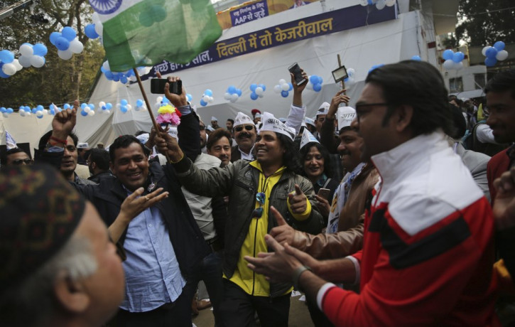 Supporters of the Aam Aadmi Party, or "common man's" party, celebrate as initial results show the party in the lead, at their party office in New Delhi, India, Tuesday, Feb. 11, 2020.