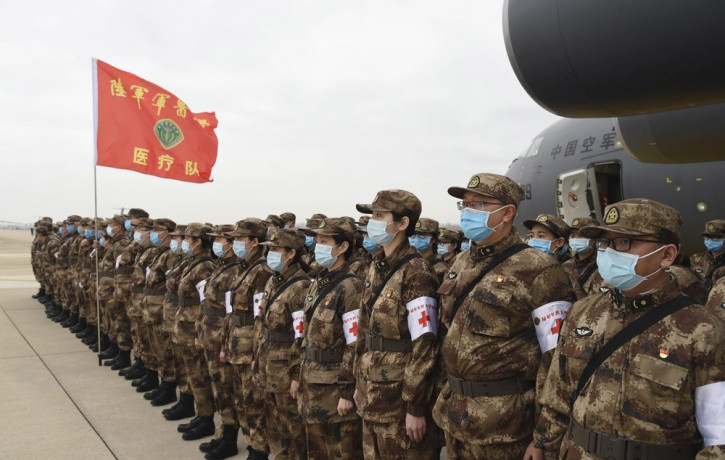 In this photo released by China's Xinhua News Agency, Chinese military medics arrive at the Tianhe International Airport in Wuhan, central China's Hubei Province, Feb. 13, 2020.