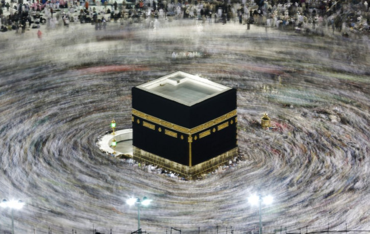 In this Aug. 13, 2019, file photo taken with a slow shutter speed, Muslim pilgrims circumambulate the Kaaba, the cubic building at the Grand Mosque, during the hajj pilgrimage in the Muslim h