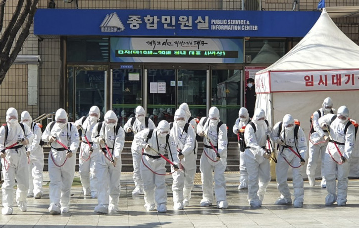 South Korean soldiers wearing protective suits spray disinfectant to prevent the spread of a new coronavirus in front of the Daegu city hall in Daegu, South Korea, Monday, March 2, 2020.
