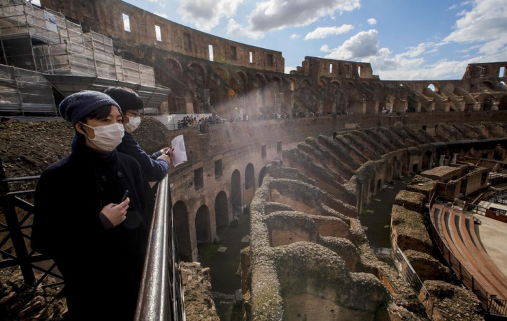 Tourists visit the Colosseum, in Rome, Saturday, March 7, 2020.