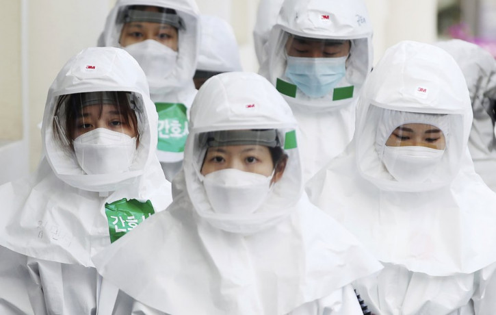 Medical staff members arrive for a duty shift at Dongsan Medical Center in Daegu, South Korea, Monday, March 30, 2020.