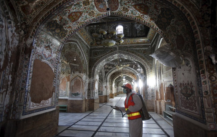 A worker disinfects a mosque for coronavirus, in Peshawar, Pakistan, Thursday, April 2, 2020. The government imposed a nationwide lockdown to try to contain the outbreak of the virus.