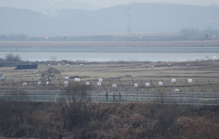 In this Dec. 16, 2019, file photo, South Korean army soldiers patrol along the barbed-wire fence in Paju, South Korea, near the border with North Korea.