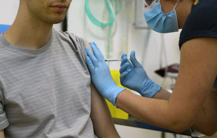 In this screen grab from video issued by Britain's Oxford University, a volunteer is injected with either an experimental COVID-19 vaccine or a comparison shot as part of the first human tria