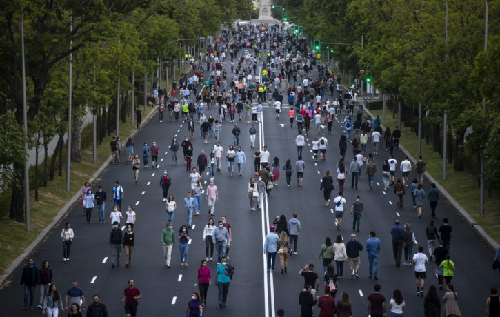 People exercise along Paseo de la Castellana after loosening of the lockdown measures imposed by the government due to coronavirus in Madrid, Spain, Saturday, May 9, 2020.