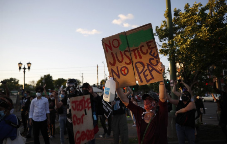 Demonstrators gather Thursday, May 28, 2020, in St. Paul, Minn. Protests over the death of George Floyd, the black man who died in police custody broke out in Minneapolis for a third straight