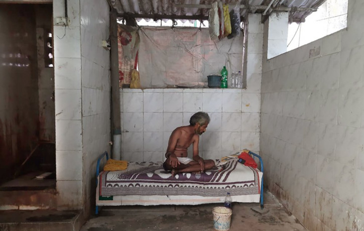Raja Kadam rests on his bed inside a toilet complex in Dharavi, one of Asia's largest slums, in Mumbai, India, Saturday, May 16, 2020.