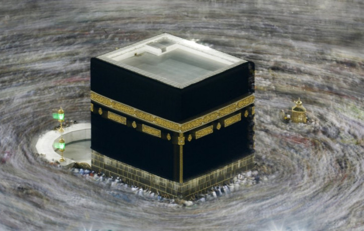 In this Aug. 13, 2019 file photo taken with slow shutter speed, Muslim pilgrims circumambulate the Kaaba, the cubic building at the Grand Mosque, durning the hajj pilgrimage in the Muslim hol
