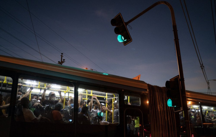 Commuters, some wearing protective face masks, ride a bus amid the new coronavirus pandemic in Rio de Janeiro, Brazil, Thursday, June 25, 2020.