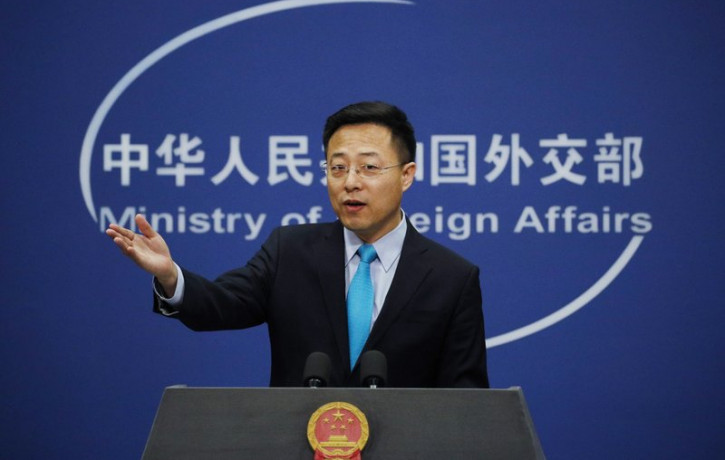 FILE - In this Feb. 24, 2020, file photo, Chinese Foreign Ministry spokesman Zhao Lijian gestures as he speaks during a daily briefing at his ministry in Beijing.