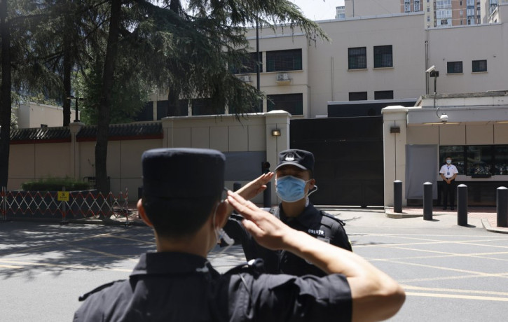 Chinese SWAT officers salute each other at the former United States Consulate in Chengdu in southwest China's Sichuan province on Monday, July 27, 2020 after Chinese authorities took control 