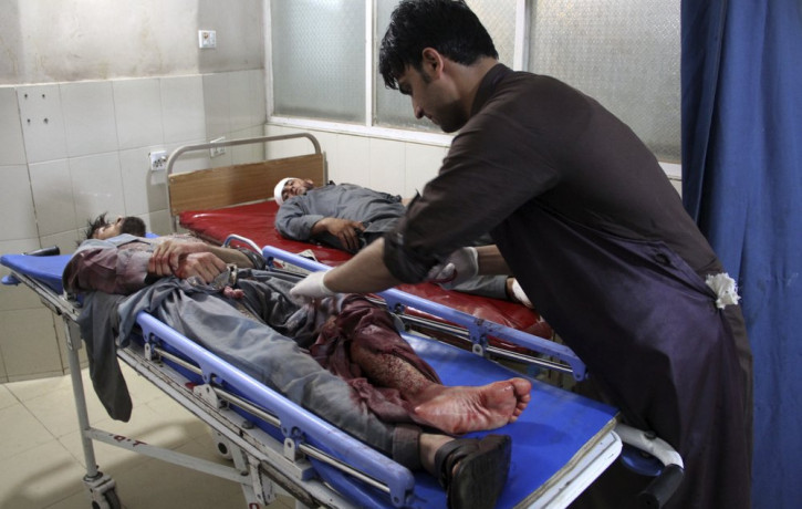 A wounded man receives treatment at a hospital after a suicide car bomb and multiple gunmen attack in the city of Jalalabad, east of Kabul, Afghanistan, Sunday, Aug. 2, 2020.
