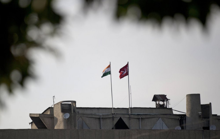 In this Aug. 9, 2019, file photo, an Indian national flag, left, is hoisted next to a Jammu and Kashmir state flag on the government secretariat building after New Delhi scrapped the disputed