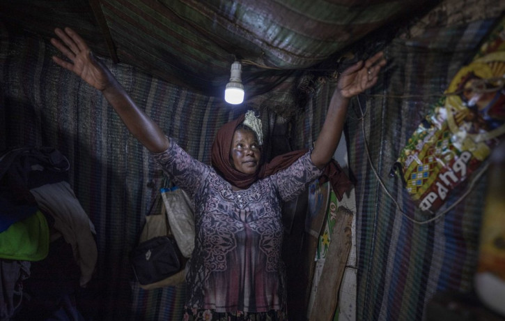 Mother of two Amsale Hailemariam, a domestic worker who lost work because of the coronavirus, stands in her small tent in the capital Addis Ababa, Ethiopia on Friday, June 26, 2020.