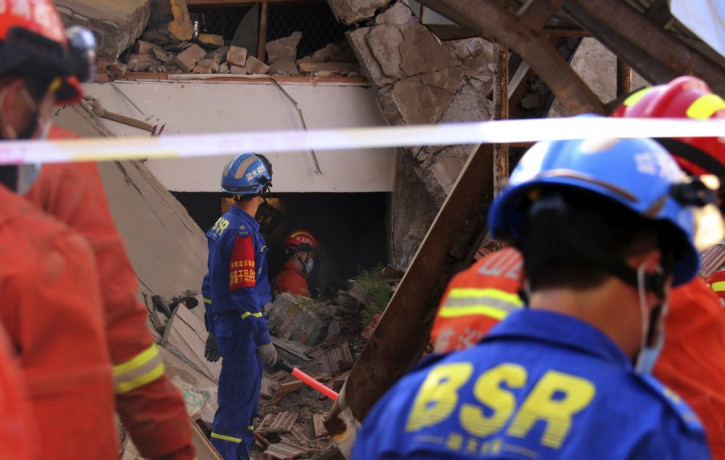 Rescuers search for victims in the aftermath of the collapse of a two-story restaurant in Xiangfen county in northern China's Shanxi province on Saturday, Aug. 29, 2020.