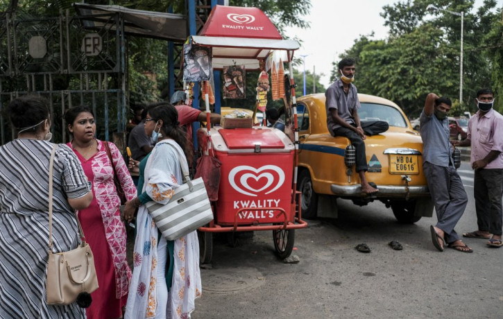 Taxi drivers wearing face masks wait for passengers in Kolkata, India, Saturday, Aug. 29, 2020. India has the third-highest coronavirus caseload after the United States and Brazil, and the fo